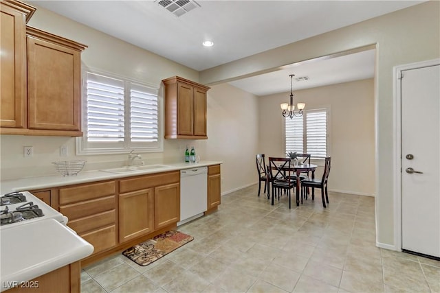 kitchen featuring visible vents, dishwasher, light countertops, and a sink