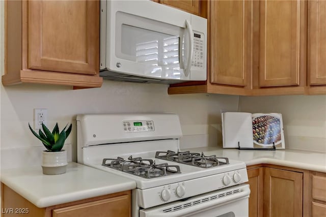 kitchen with decorative backsplash, white appliances, and light countertops