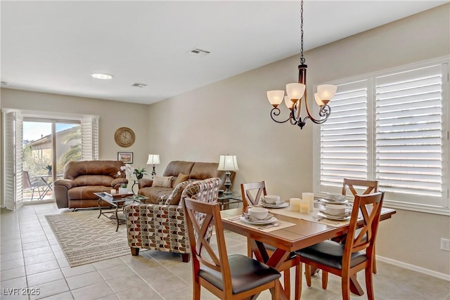 dining room featuring light tile patterned floors, visible vents, baseboards, and a notable chandelier