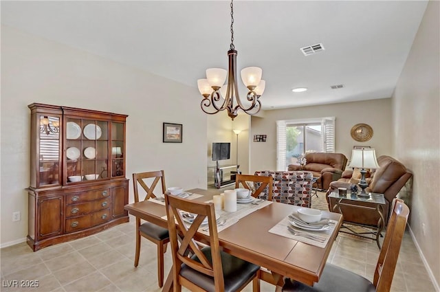 dining space with visible vents, baseboards, an inviting chandelier, and light tile patterned flooring