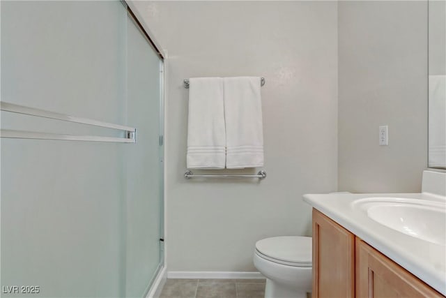 bathroom featuring vanity, baseboards, a shower with shower door, tile patterned flooring, and toilet