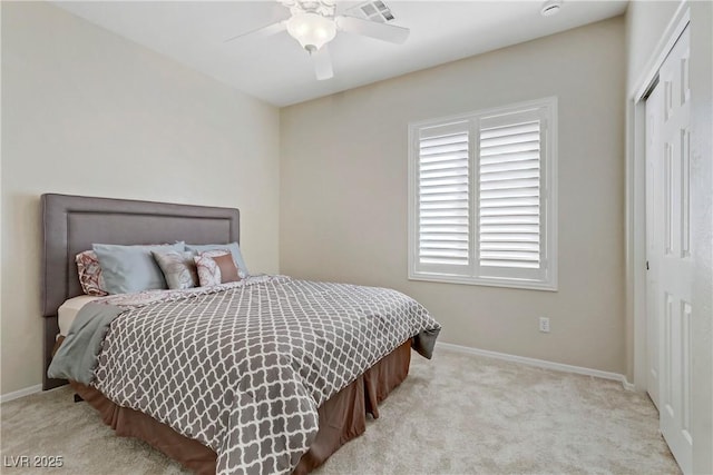 bedroom with a ceiling fan, baseboards, a closet, and carpet floors