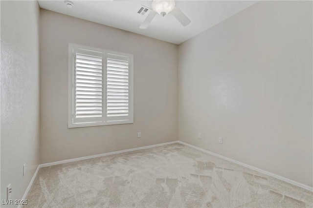 spare room featuring baseboards, visible vents, a ceiling fan, and carpet