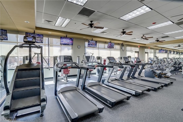 exercise room with a drop ceiling and visible vents