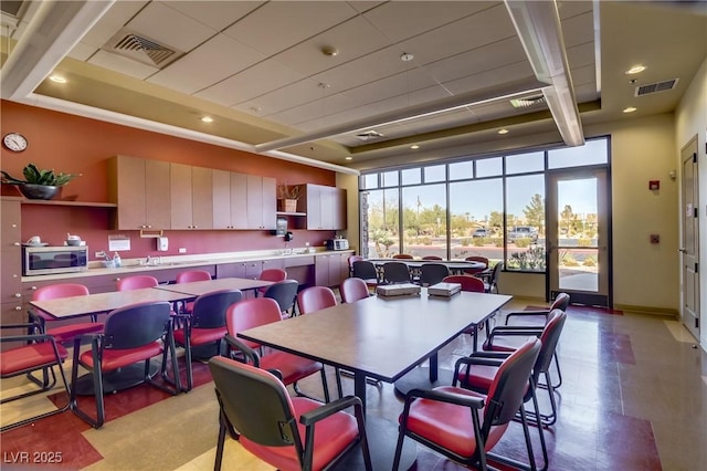 dining area with visible vents, recessed lighting, and a tray ceiling