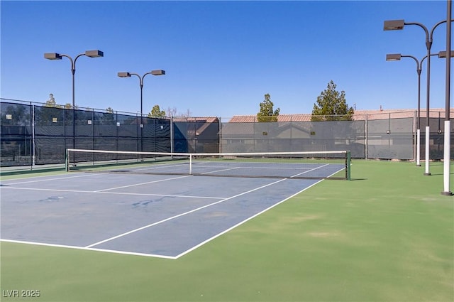 view of tennis court with fence