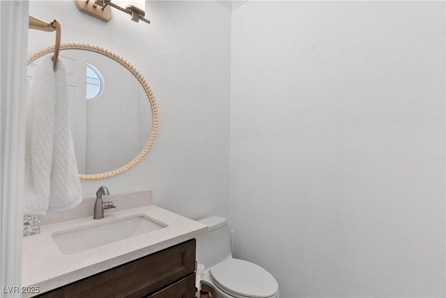 bathroom featuring toilet and vanity