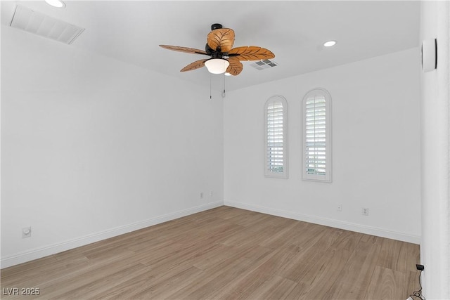 unfurnished room with light wood-type flooring, visible vents, baseboards, and ceiling fan