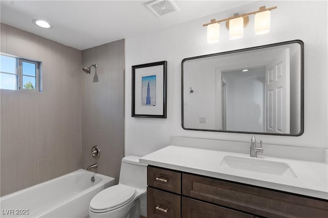 bathroom featuring washtub / shower combination, visible vents, toilet, and vanity