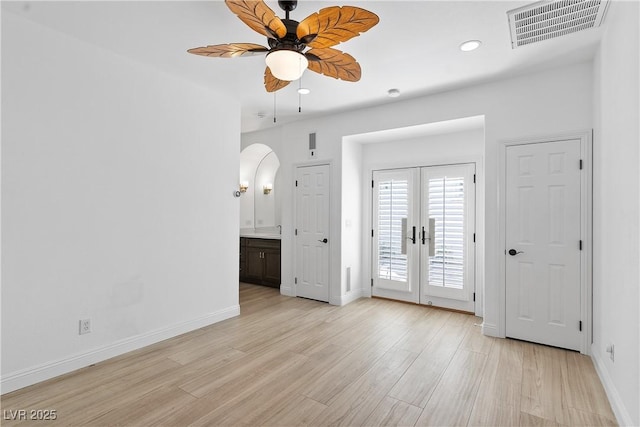 interior space with visible vents, baseboards, light wood-style flooring, access to exterior, and french doors