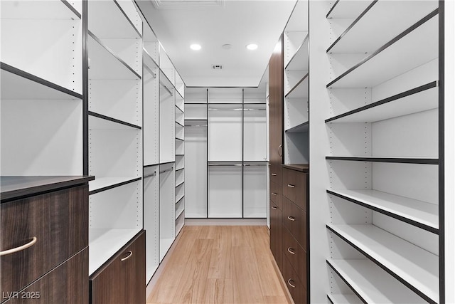 spacious closet featuring visible vents and light wood finished floors