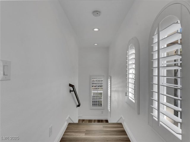 stairs featuring recessed lighting, wood finished floors, and baseboards