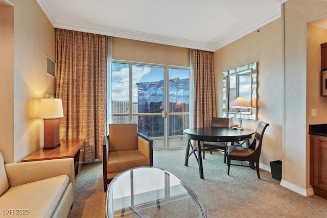 sitting room featuring crown molding, a view of city, baseboards, and visible vents