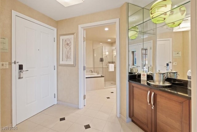 bathroom featuring vanity, baseboards, a stall shower, french doors, and a garden tub