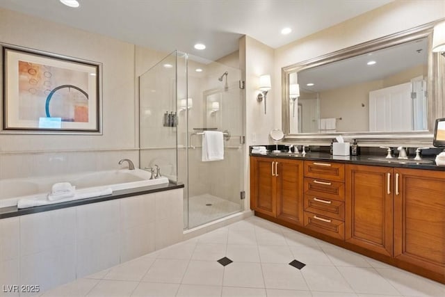 full bath featuring double vanity, a sink, a shower stall, a garden tub, and tile patterned floors