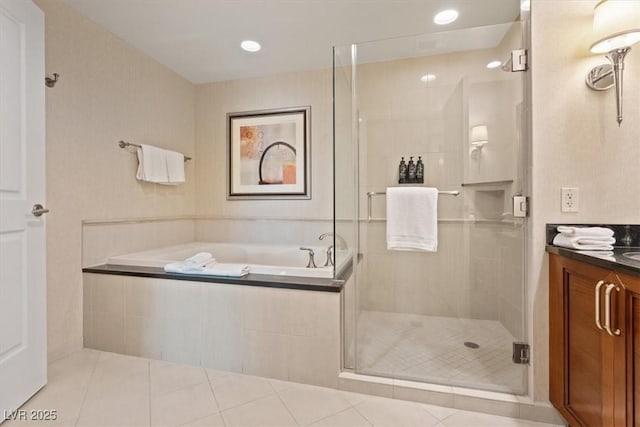 bathroom with vanity, tile patterned floors, a garden tub, and a stall shower