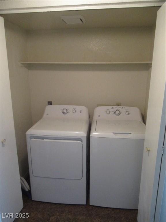 washroom featuring laundry area, visible vents, and washing machine and clothes dryer