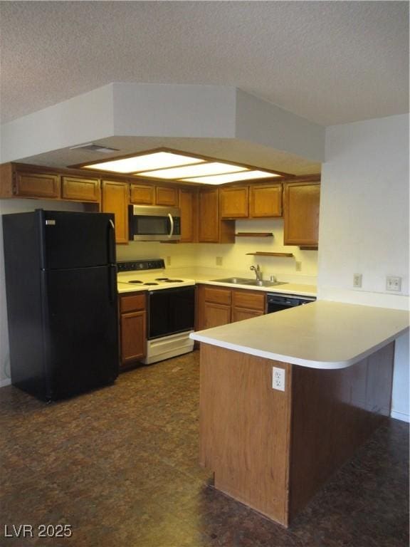 kitchen with light countertops, a peninsula, a textured ceiling, black appliances, and a sink