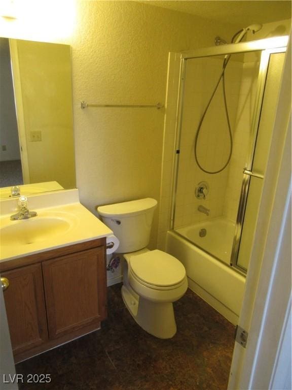 bathroom featuring enclosed tub / shower combo, toilet, and vanity