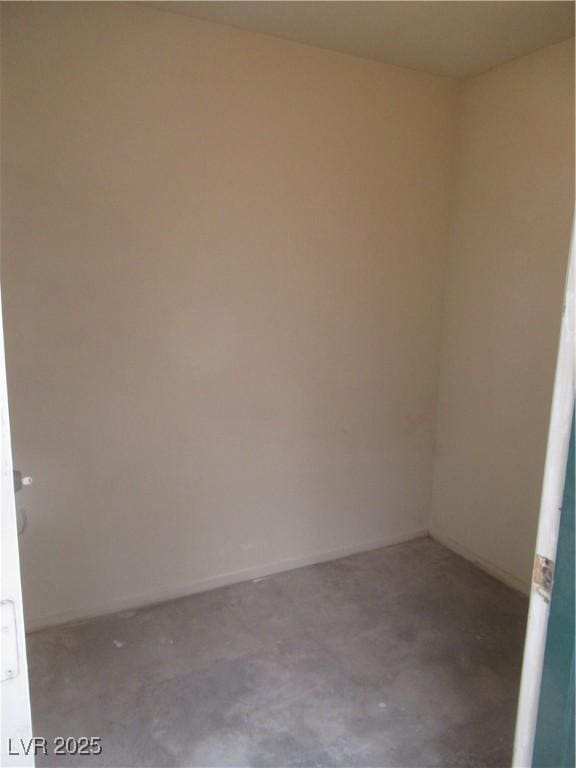 unfurnished room featuring concrete floors