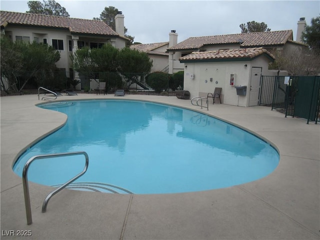 pool featuring a patio and fence