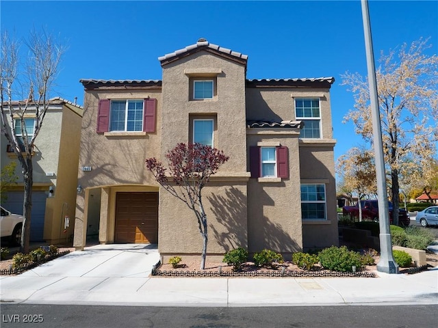 view of front of house featuring a tile roof, stucco siding, driveway, and an attached garage