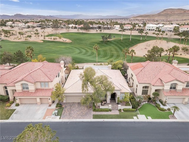 drone / aerial view with a mountain view, a residential view, and golf course view