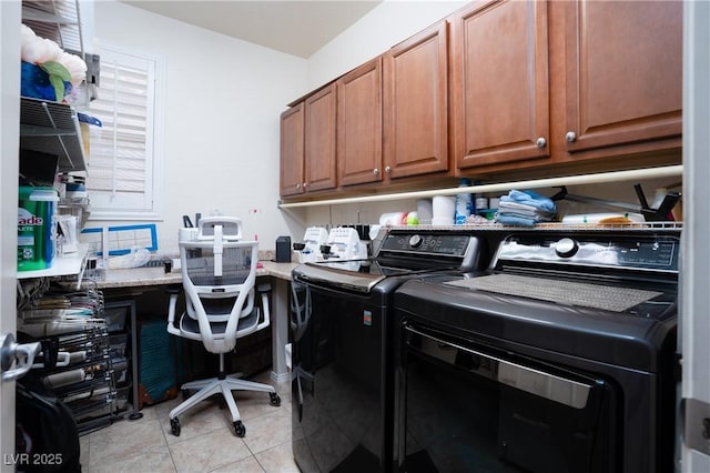 laundry area featuring washer and clothes dryer, cabinet space, and light tile patterned flooring