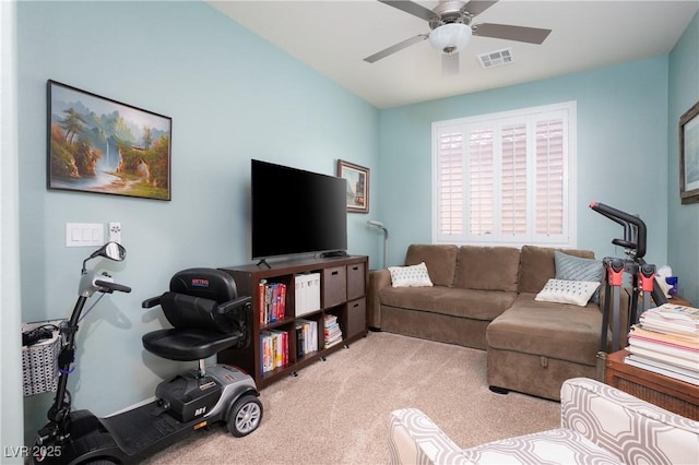 living room featuring visible vents, light carpet, and a ceiling fan