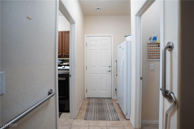 interior space with light tile patterned floors and visible vents