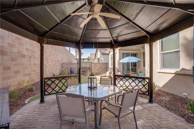 609 Viale Machiavelli Ln, Henderson, NV 89011 - view of patio / terrace featuring a ceiling fan, a fenced backyard, a gazebo, and outdoor dining area