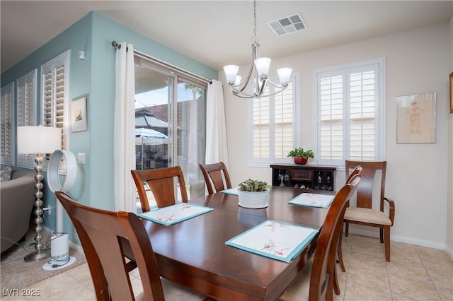 dining area with a notable chandelier, visible vents, baseboards, and light tile patterned floors