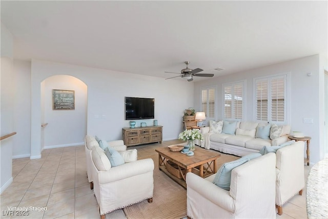 609 Viale Machiavelli Ln, Henderson, NV 89011 - living room with arched walkways, ceiling fan, and light tile patterned floors