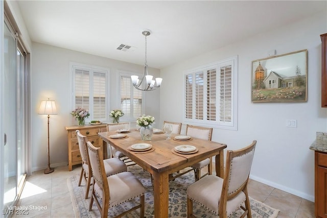 609 Viale Machiavelli Ln, Henderson, NV 89011 - dining space featuring a chandelier, healthy amount of natural light, light tile patterned floors, and baseboards
