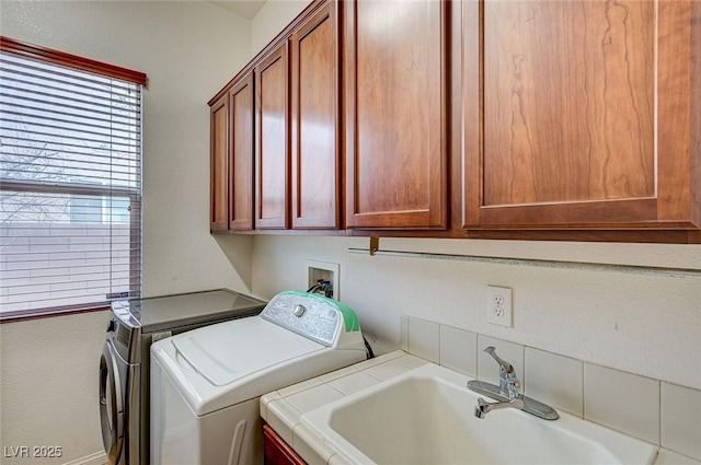 laundry area with washer and dryer, cabinet space, and a sink