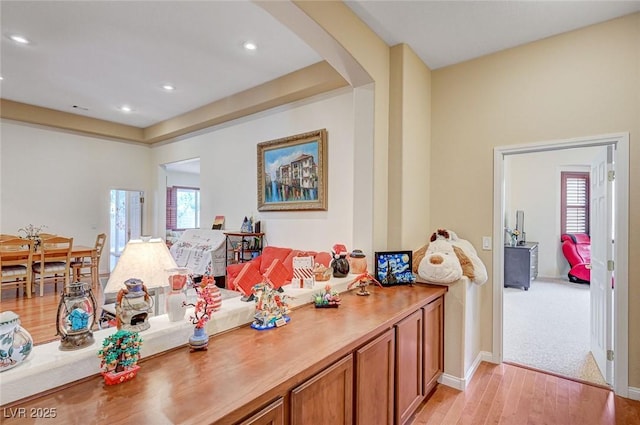 interior space with arched walkways, recessed lighting, light wood-type flooring, and baseboards