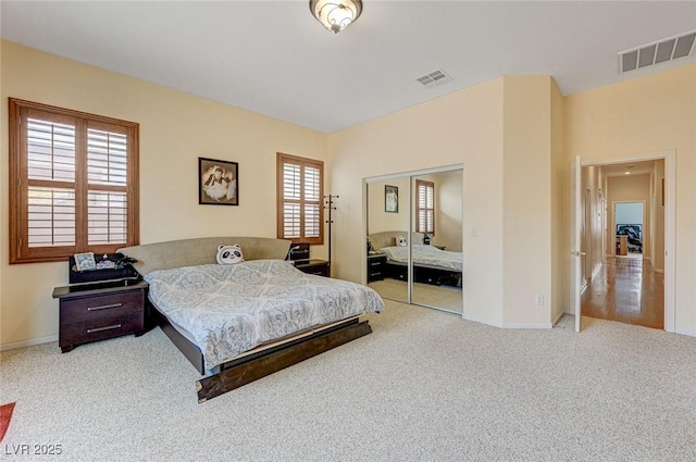 bedroom with a closet, baseboards, visible vents, and carpet floors