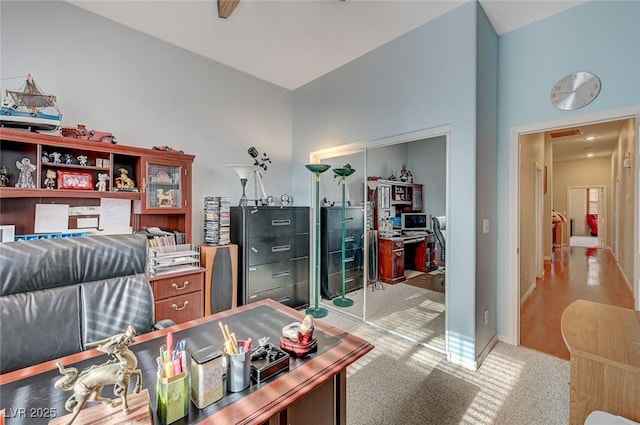 office space featuring baseboards and light colored carpet