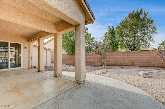 view of patio / terrace featuring fence