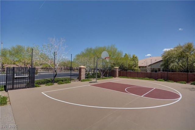 view of basketball court with community basketball court and fence