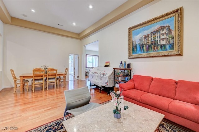 living area featuring recessed lighting, light wood-style floors, visible vents, and baseboards