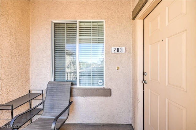 property entrance featuring stucco siding