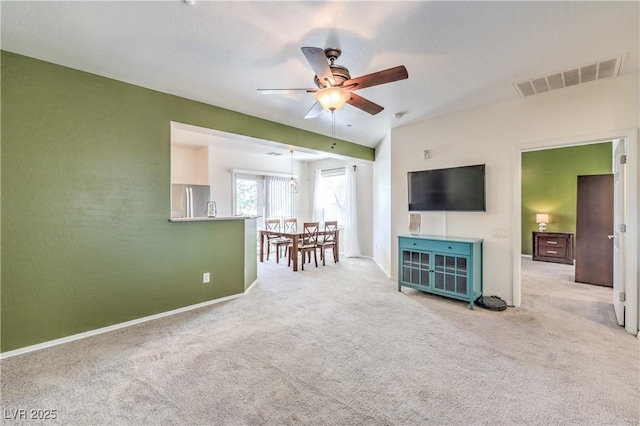 unfurnished living room featuring visible vents, baseboards, carpet, and ceiling fan