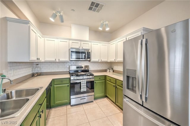 kitchen featuring visible vents, a sink, white cabinetry, appliances with stainless steel finishes, and green cabinetry