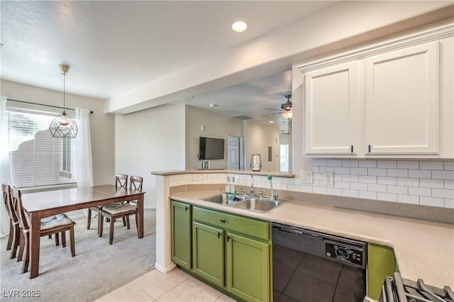 kitchen featuring backsplash, green cabinets, black dishwasher, and a sink