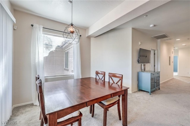 dining room featuring light carpet and baseboards