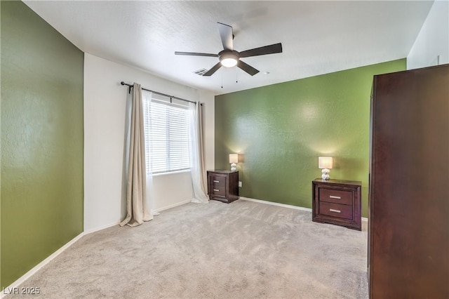 unfurnished bedroom featuring ceiling fan, baseboards, and carpet