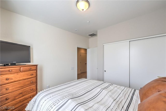 bedroom with visible vents and a closet