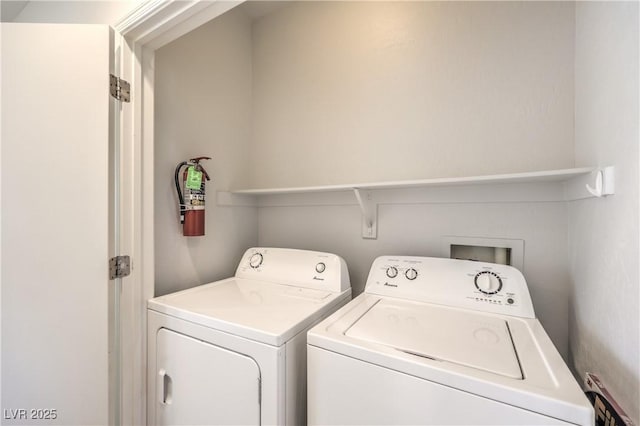 laundry area with separate washer and dryer and laundry area