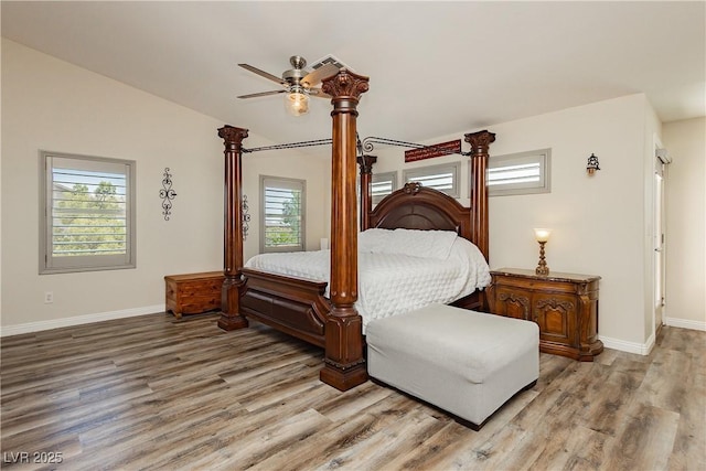 bedroom featuring visible vents, baseboards, and wood finished floors